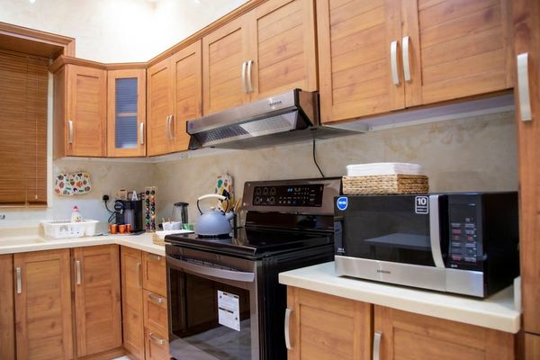 Before and after comparison of a treated kitchen cabinet area showing clean pest control documentation