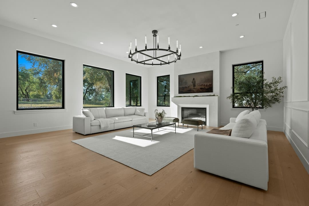 Spacious modern living room with white sofas and fireplace