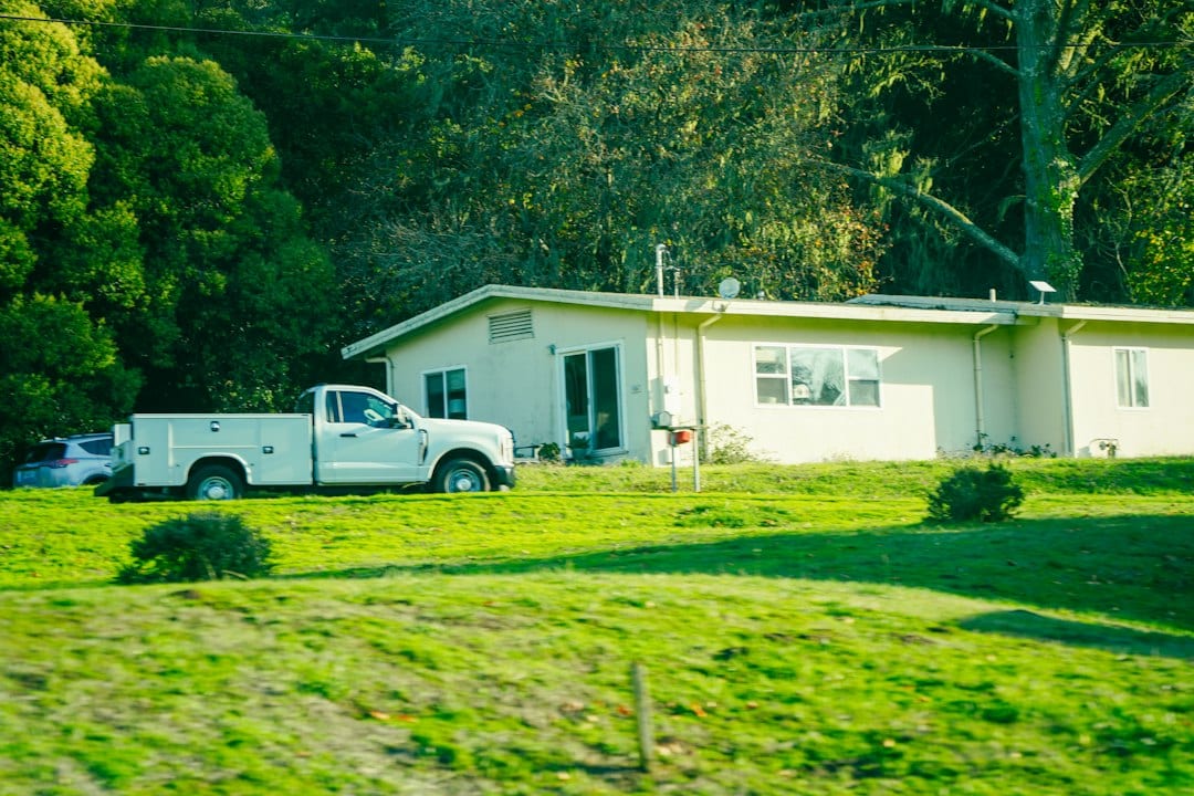 Professional pest control technician treating a residential home
